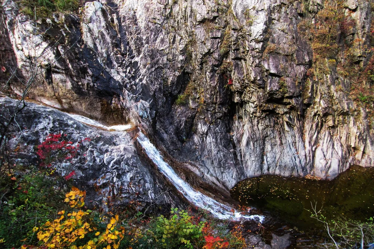 Waterfall in a Seoraksan gorge with autumn foliage